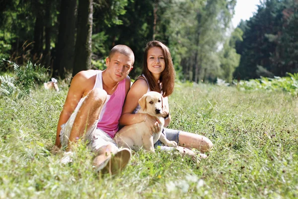 Couple with their puppy — Stock Photo, Image