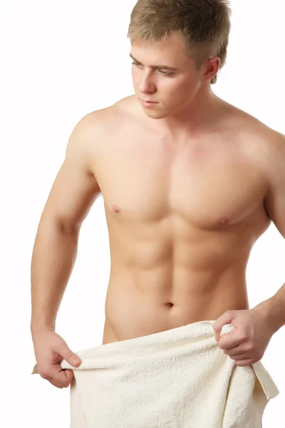 Nude young man covering himself with a towel — Stock Photo, Image