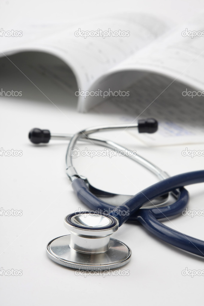 A medical stetoscope near papers