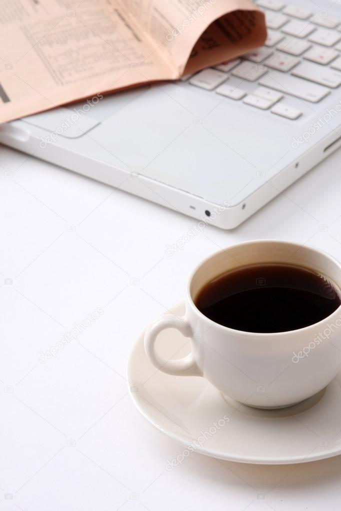 Coffee cup near the laptop