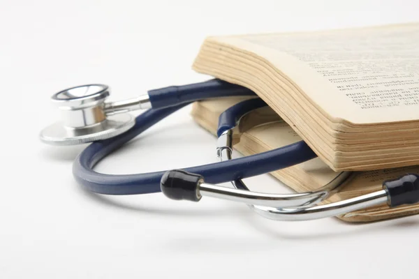 Medical stethoscope between book pages — Stock Photo, Image