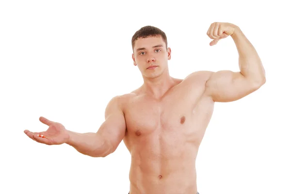 Young muscular man with pills — Stock Photo, Image