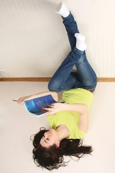 Chica universitaria leyendo al revés — Foto de Stock