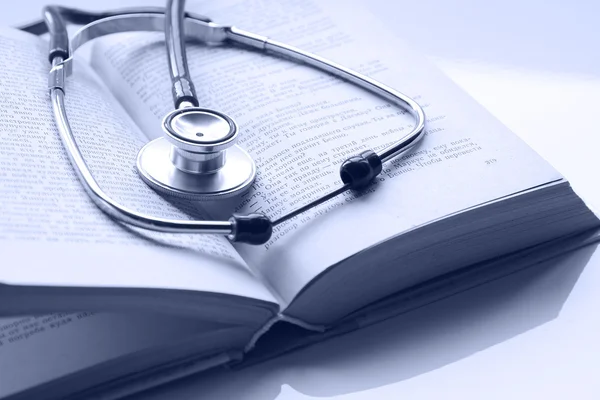 Stethoscope on an open book — Stock Photo, Image