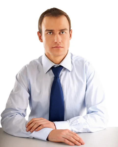 Businessman sitting on the desk in office — Stock Photo, Image