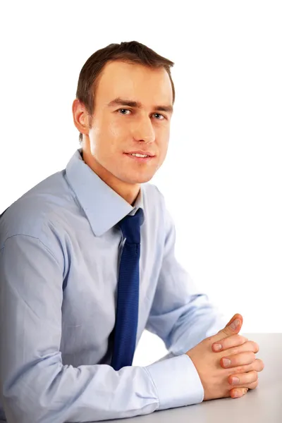 Businessman sitting on the desk in office — Stock Photo, Image