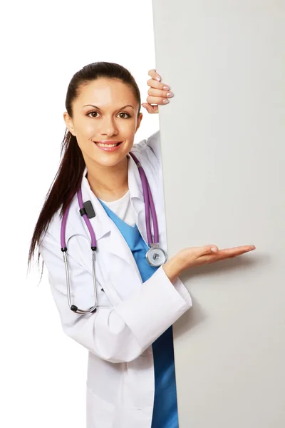 Female doctor pointing on an empty blank — Stock Photo, Image