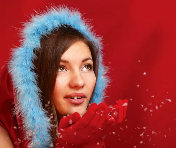 Woman blowing snowflakes — Stock Photo, Image