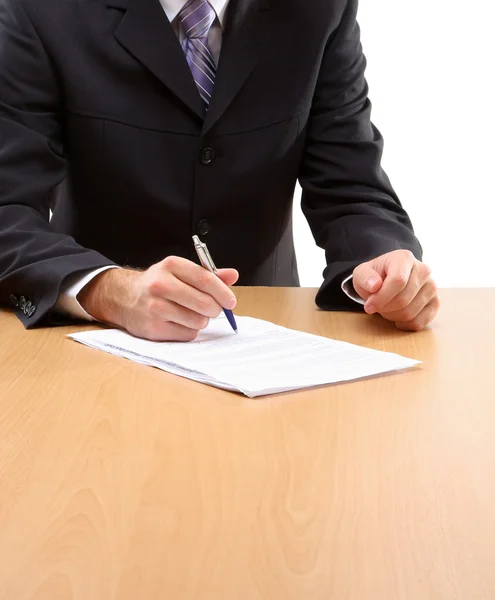 Hombre de negocios desconocido sentado en el escritorio Imagen de stock