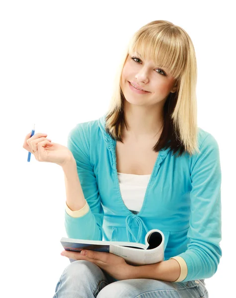 Chica universitaria con un bolígrafo y un libro de texto Imagen de stock