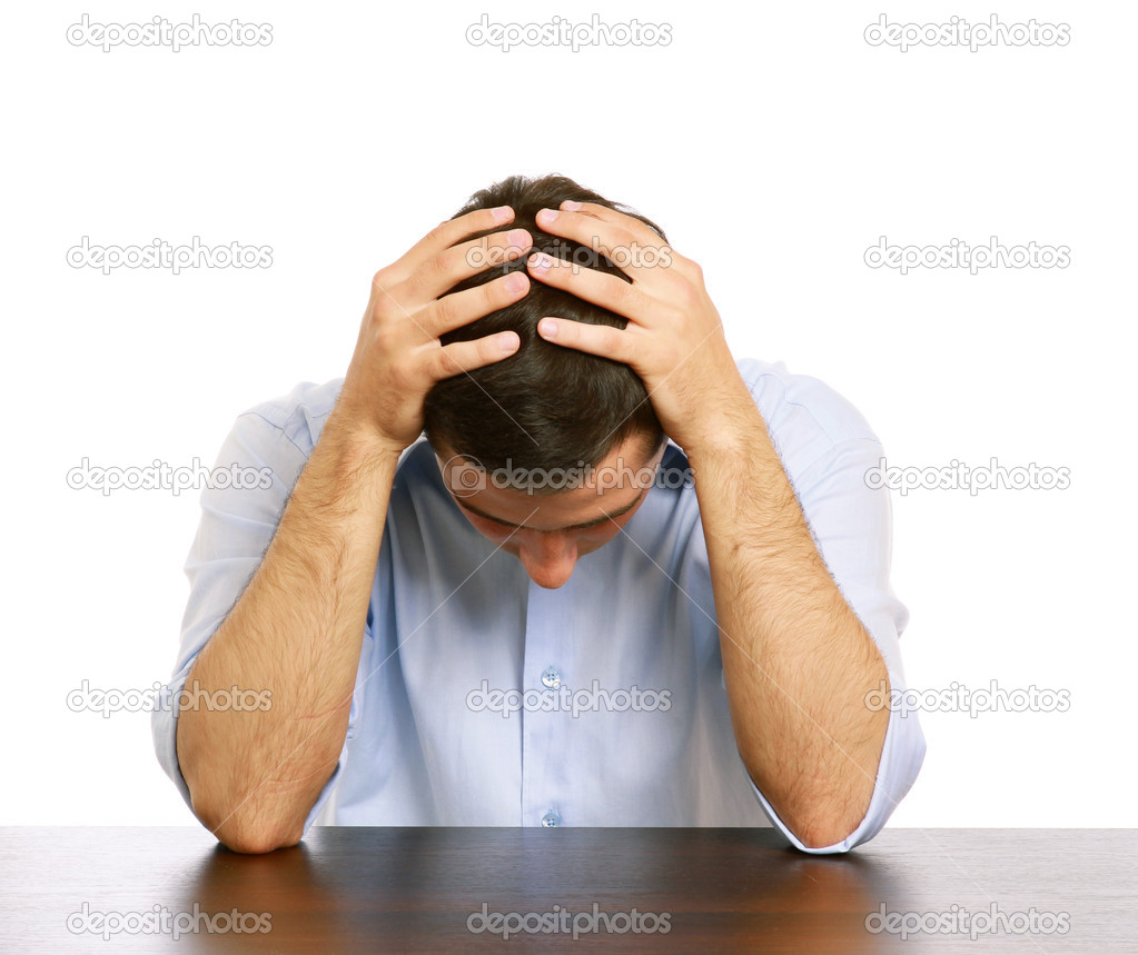 Man with a headache at the desk