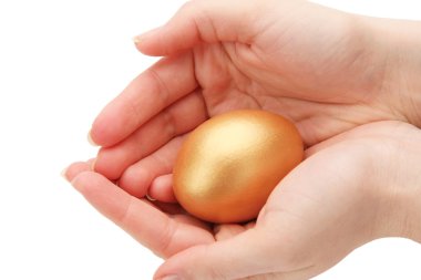 A golden egg in a female hand clipart