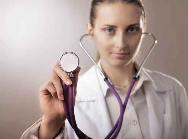 Young female doctor listening — Stock Photo, Image