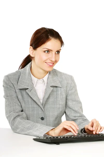 Businesswoman sitting on the desk — Stock Photo, Image