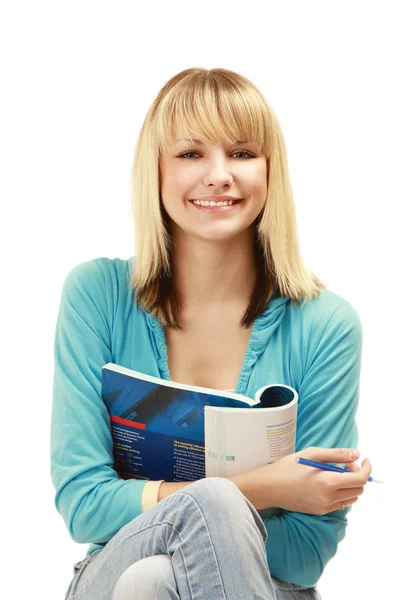 Chica universitaria con un bolígrafo y un libro de texto —  Fotos de Stock