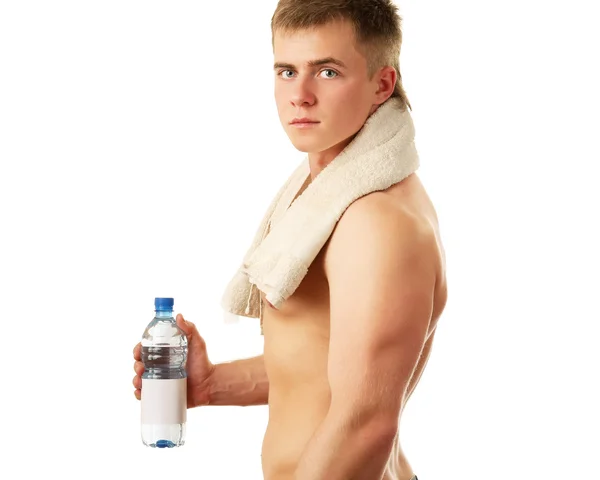 Muskulös man med en flaska vatten — Stockfoto