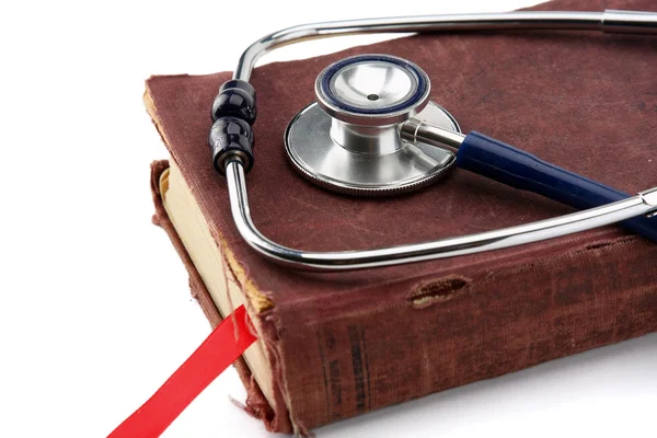 A medical stethoscope over a book — Stock Photo, Image