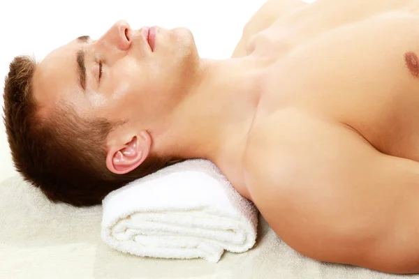 Young smart male enjoying massage — Stock Photo, Image