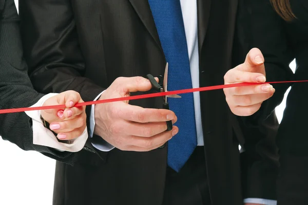 Gente de negocios cortando una cinta roja — Foto de Stock