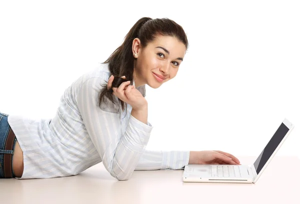 Girl with a laptop lying on the floor — Stock Photo, Image