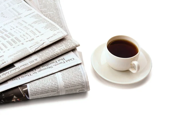 Cup of coffee and stack of newspapers — Stock Photo, Image