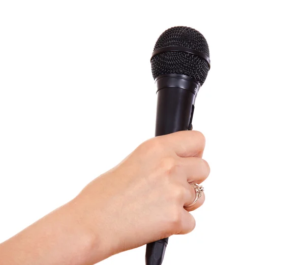 Mano femenina sosteniendo un micrófono — Foto de Stock