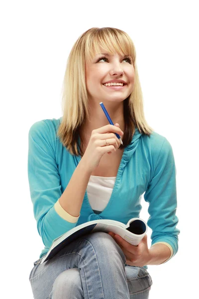 College girl con una penna e un libro di testo Immagini Stock Royalty Free