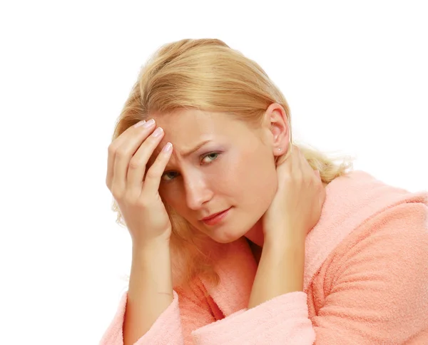 Woman in a bathrobe suffers from a headache Stock Picture