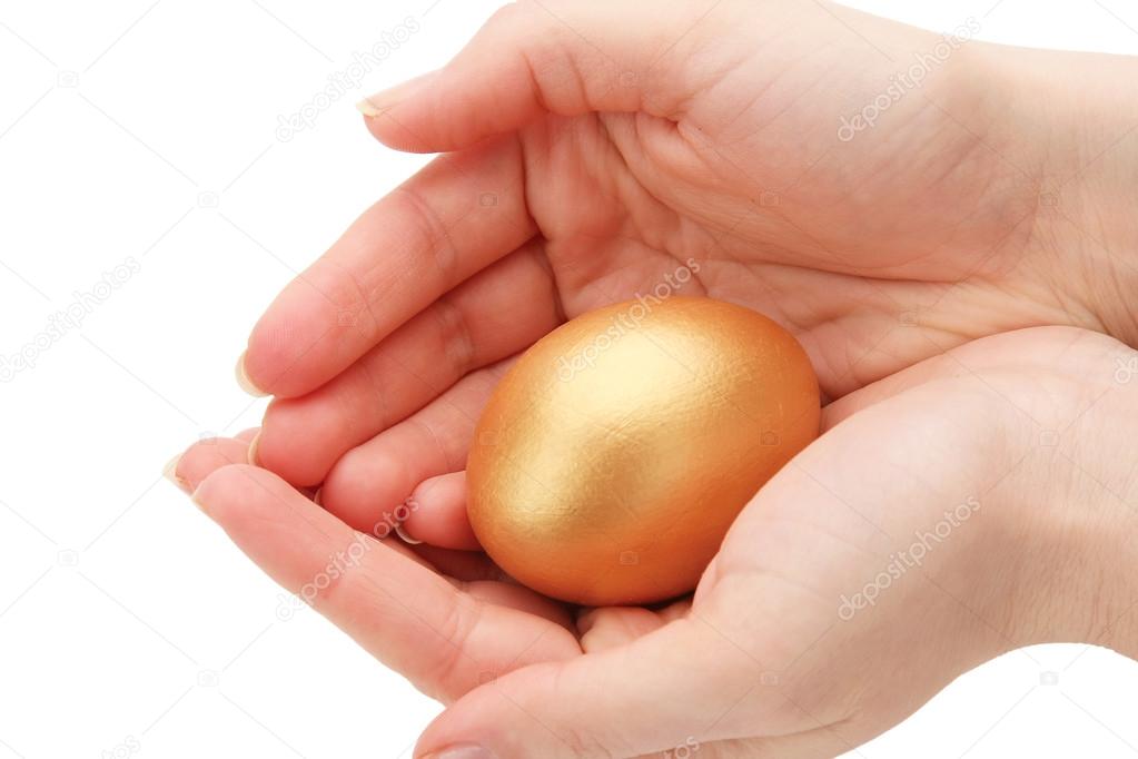 A golden egg in a female hand