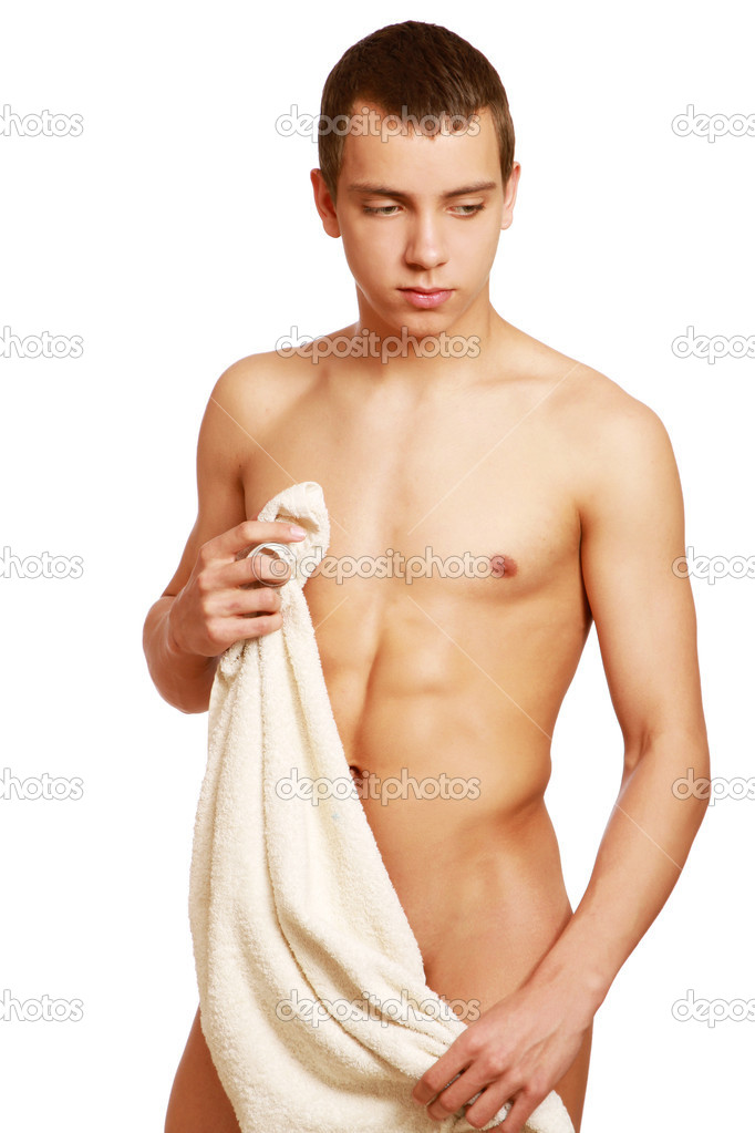 Nude young man covering himself with a towel