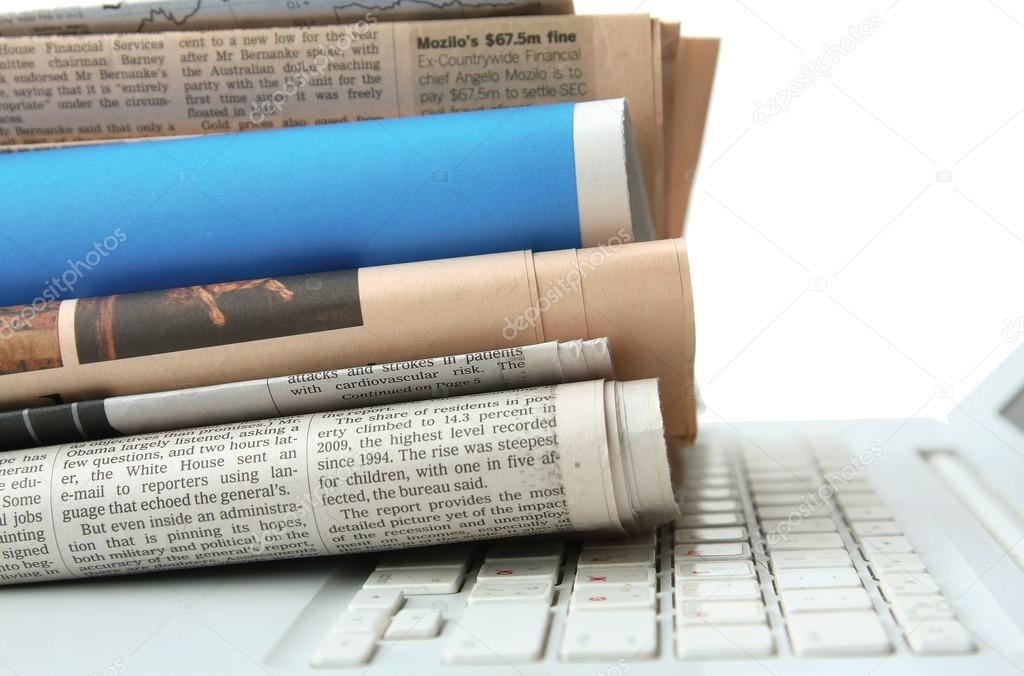 Stack of newspaper  on  laptop