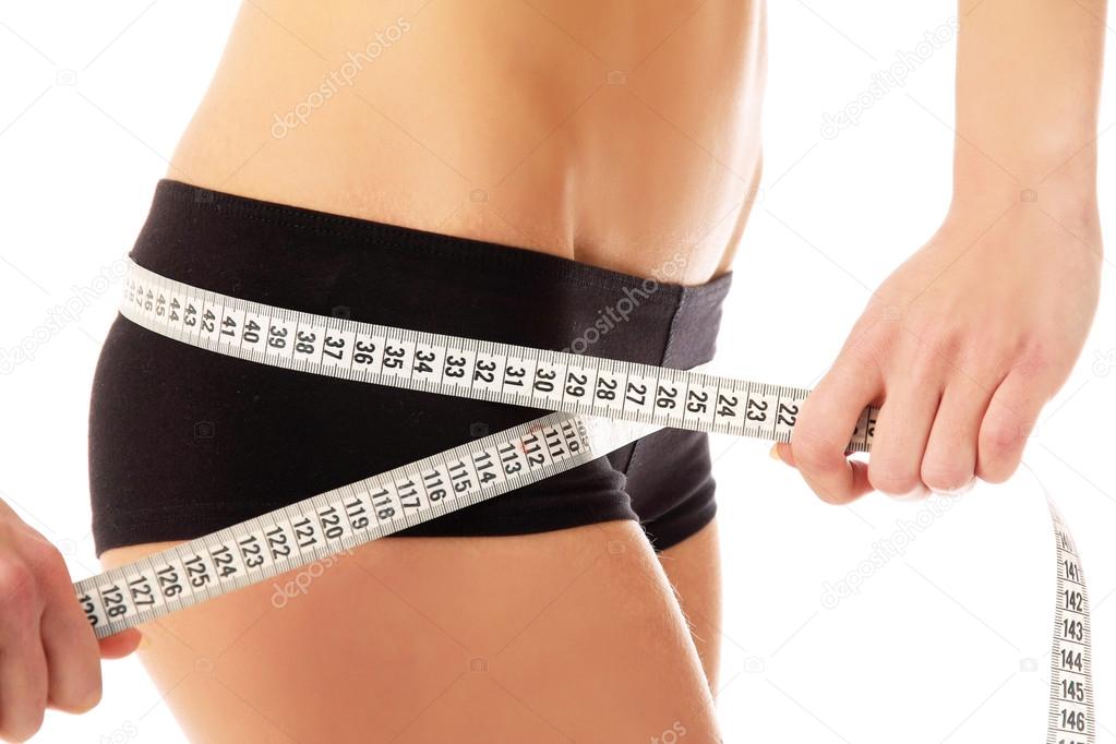 Woman measure her waist belly by metre-stick