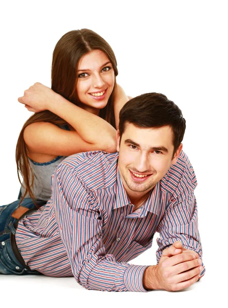 Young caucasian couple lying on floor and hugging — Stock Photo, Image