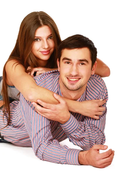Young caucasian couple lying on floor and hugging — Stock Photo, Image