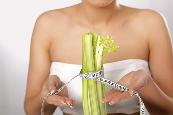 Mujer joven con verduras y cinta métrica —  Fotos de Stock