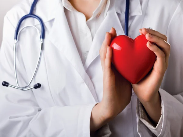 Doctor with stethoscope holding hear — Stock Photo, Image