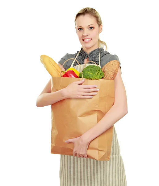 Woman in apron with grocery bag — Stock Photo, Image