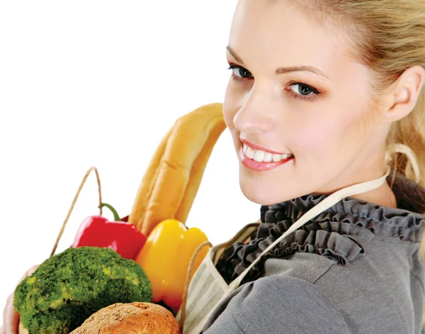 Woman in apron with grocery bag — Stock Photo, Image