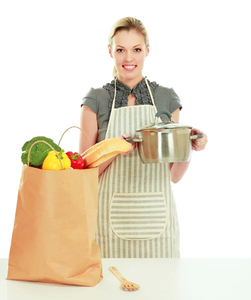 Woman on a kitchen and holding a pan — Stock Photo, Image