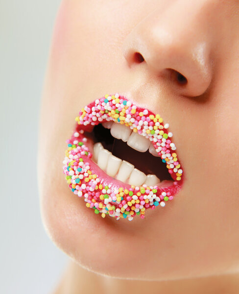 Woman lips with multicolored pearls