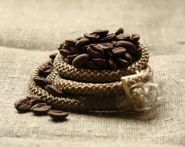 Coffee beans on a linen textute — Stock Photo, Image