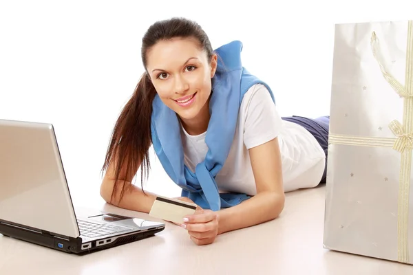 Mulher com laptop e segurando cartão de crédito — Fotografia de Stock