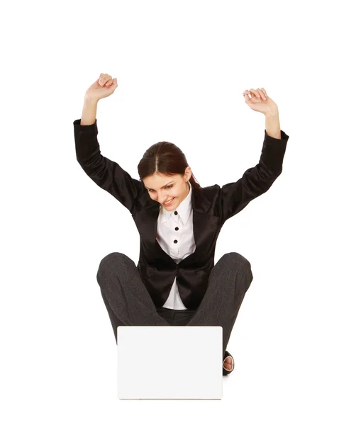 Girl sitting on the floor in front of her laptop — 图库照片