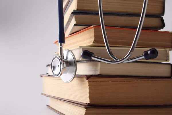 Stethoscope on pile of books isolated — Stock Photo, Image