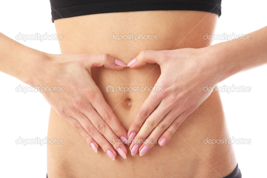 Woman forming heart shape on belly