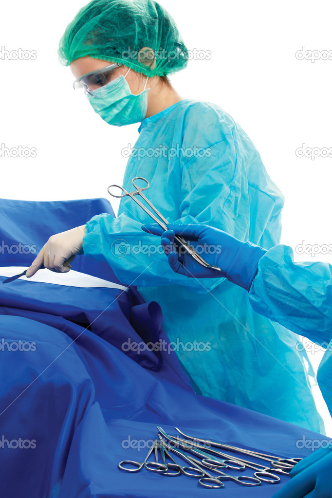 Surgeon holding medical instruments