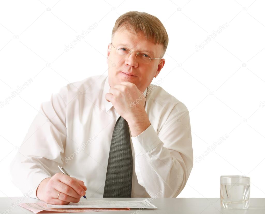 Businessman sitting on the desk and writing