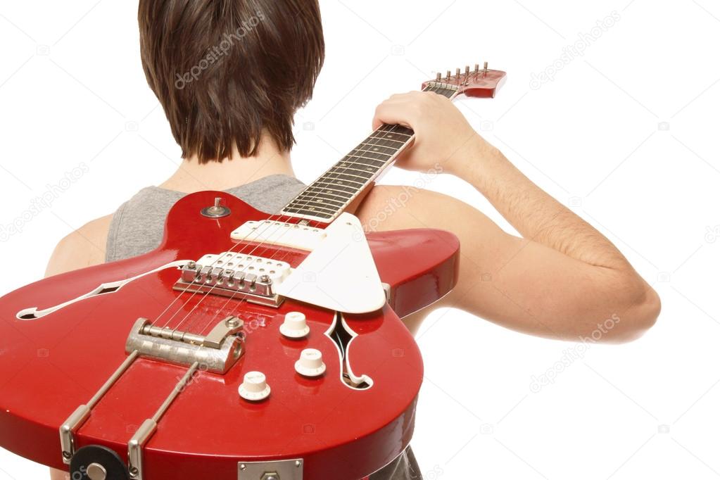 boy standing with his back with bass guitar