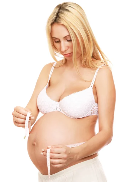 Pregnant woman measuring her belly — Stock Photo, Image