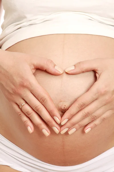 Woman touching her belly with hands — Stock Photo, Image